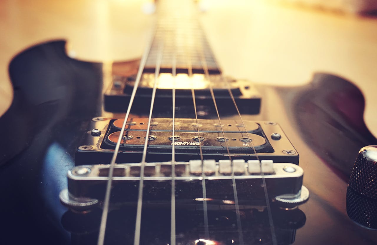 Detailed close-up of electric guitar strings and bridge, highlighting musical craftsmanship.