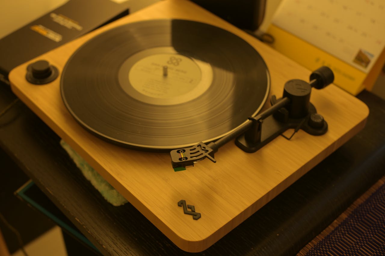 A classic wooden turntable playing a vinyl record indoors, evoking nostalgia and vintage vibes.