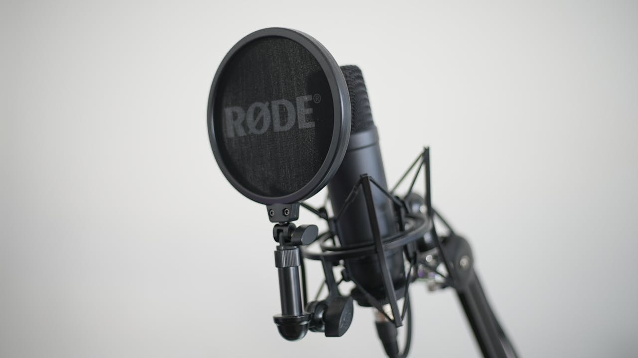 Close-up image of a condenser microphone with pop filter, ideal for music recording.
